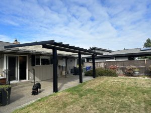 Bronze Polypanel Patio Cover With Black Cedar Embossed Wrap And Beveled Rafter Tails In Lakewood 2