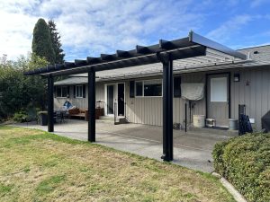Bronze Polypanel Patio Cover With Black Cedar Embossed Wrap And Beveled Rafter Tails In Lakewood 5
