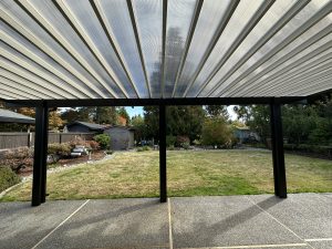Bronze Polypanel Patio Cover With Black Cedar Embossed Wrap And Beveled Rafter Tails In Lakewood 7