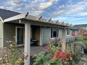 Flatpan Patio Cover With Maplewood Cedar Embossed Wrap And Scallopped Rafter Tails In Rochester